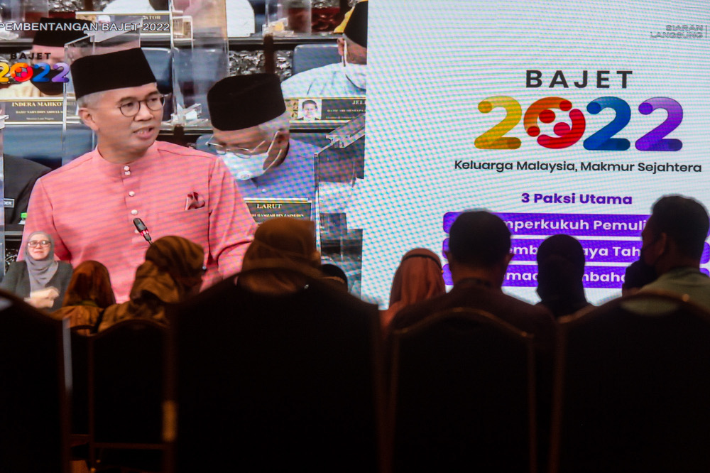 Government servants watch Finance Minister Datuk Seri Tengku Zafrul Abdul Aziz speaking during the tabling of Budget 2022 in the Dewan Rakyat, October 29, 2021. u00e2u20acu201d Picture by Shafwan Zaidon