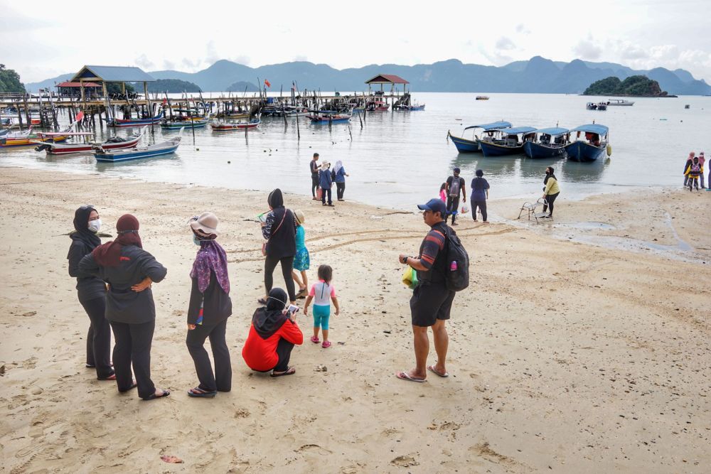 Tourists are seen waiting for their boat in Langkawi October 3, 2021. u00e2u20acu201d Picture by Ahmad Zamzahuri