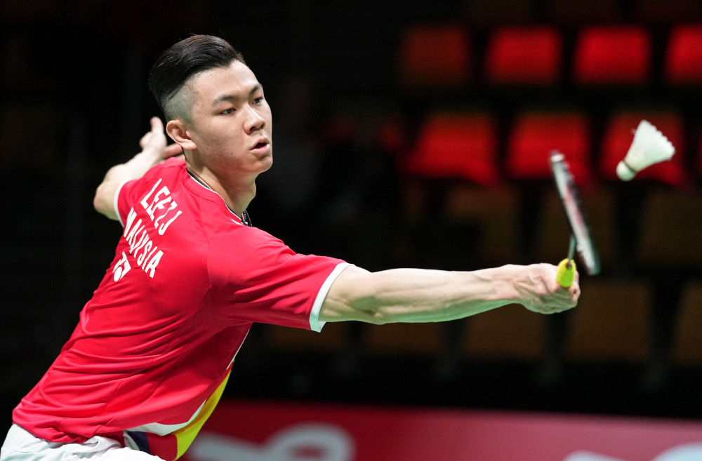 Malaysiau00e2u20acu2122s Jia Lee Zii competes with Japanu00e2u20acu2122s Kento Momota (unseen) during a menu00e2u20acu2122s single match in the Thomas Cup menu00e2u20acu2122s team Badminton match between Japan and Malaysia in in Aarhus, Denmark, October 14, 2021. u00e2u20acu201d AFP pic 