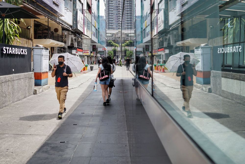 People are seen wearing protective masks as they walk along Jalan Bukit Bintang, Kuala Lumpur October 17, 2021. u00e2u20acu201d Picture by Ahmad Zamzahurinnn