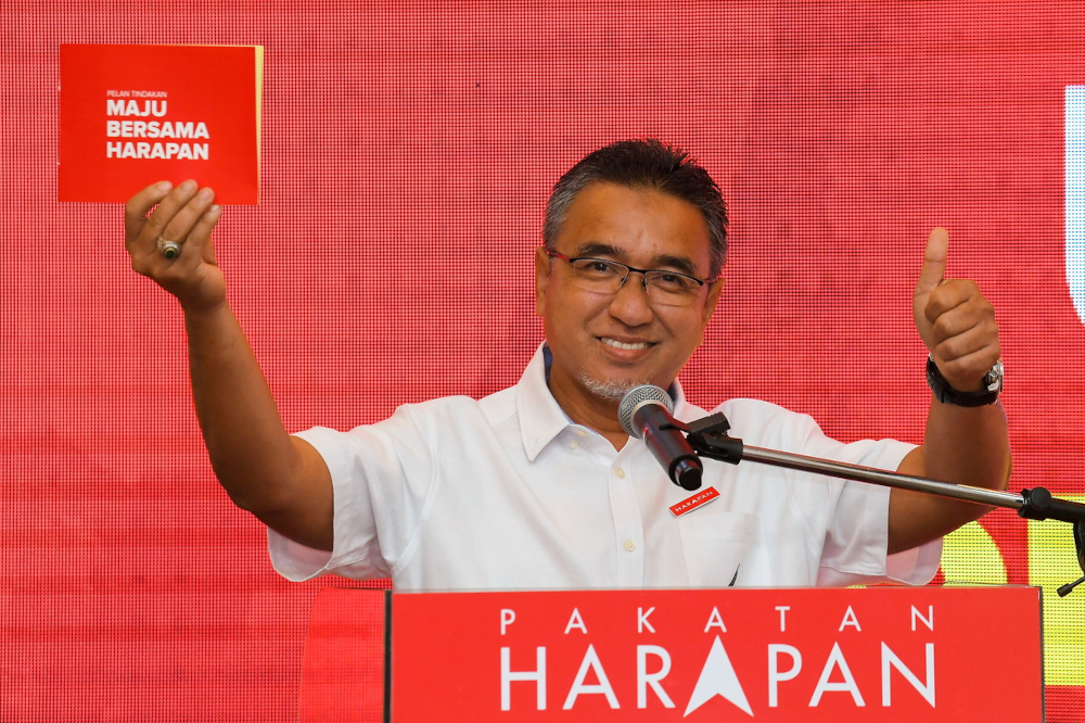 Melaka PH chairman Adly Zahari with the manifesto for the upcoming Melaka election, November 10, 2021. u00e2u20acu201d Bernama pic 
