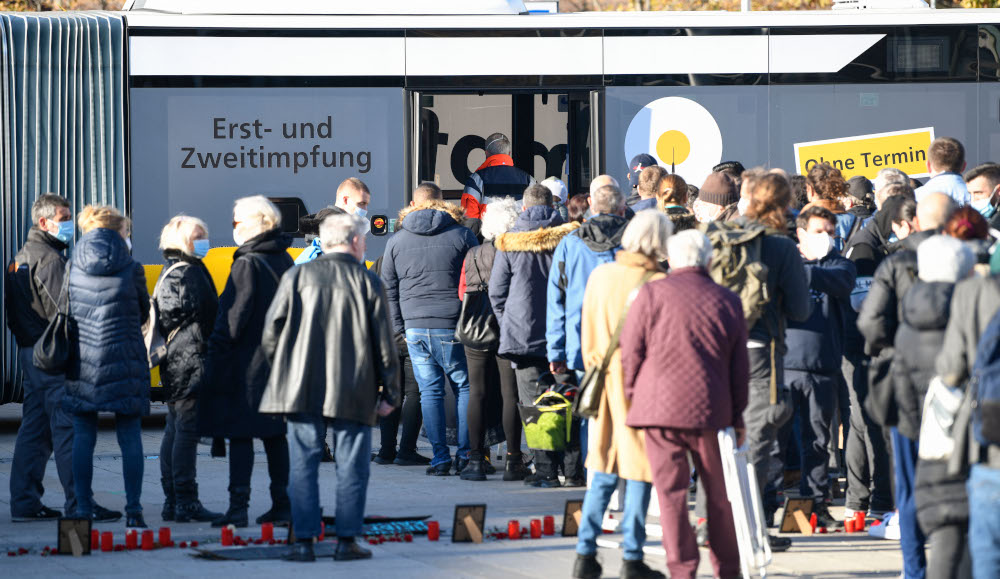 People stand in front of a vaccination bus of a mobile corona vaccination team, waiting to get their Covid-19 vaccination on the Marienplatz in Stuttgart, southern Germany, November 9, 2021. u00e2u20acu201d AFP picnn