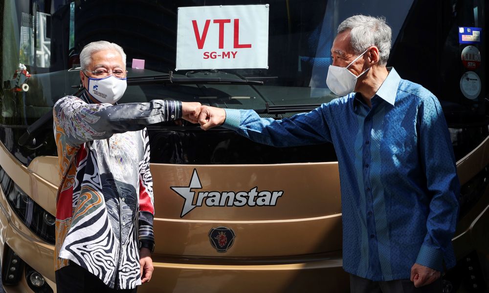 Singaporeu00e2u20acu2122s Prime Minister Lee Hsien Loong and Malaysiau00e2u20acu2122s Prime Minister Datuk Seri Ismail Sabri Yaakob bump fists during the launch of the land Vaccinated Travel Lane between both countries in Singapore November 29, 2021. u00e2u20acu201d Reuters pic