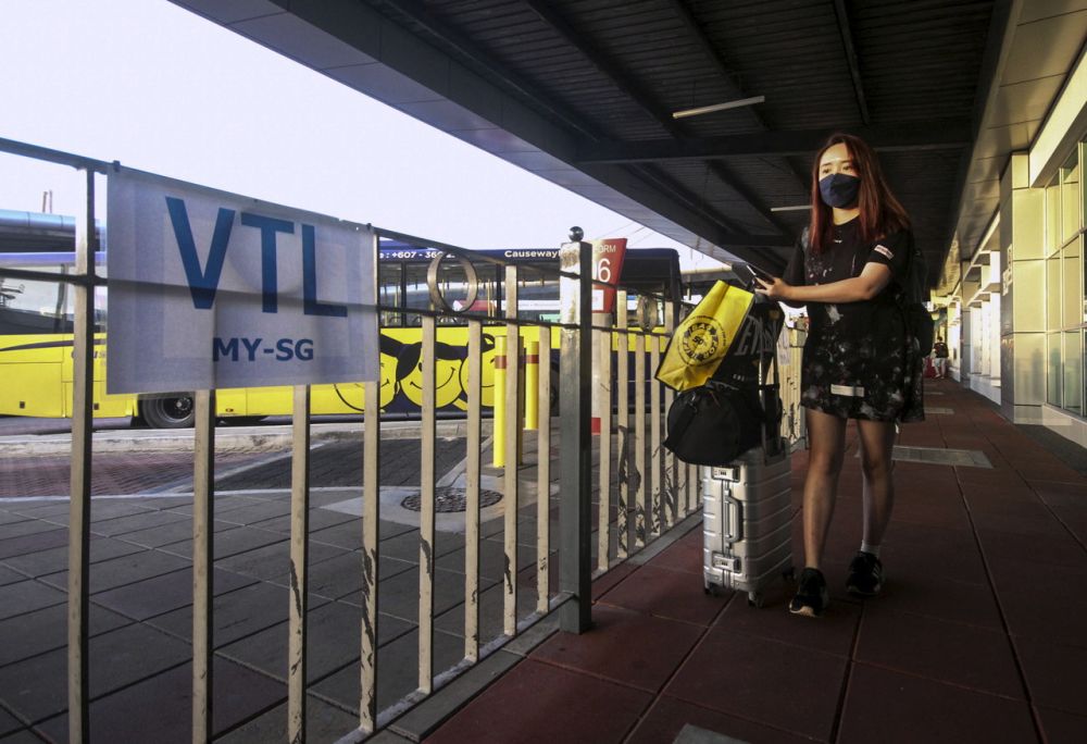 A woman waits to board a bus at the Larkin Sentral Bus Terminal in Johor Baru November 29, 2021. u00e2u20acu201d Bernama pic