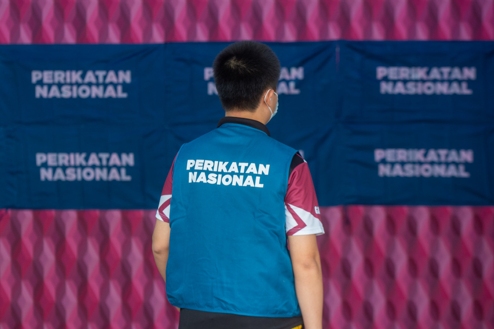 The Perikatan Nasional (PN) logo appears on a volunteeru00e2u20acu2122s apparel at the PN command centre in Kota Laksamana, Melaka, November 10, 2021. u00e2u20acu201d Picture by Shafwan Zaidon