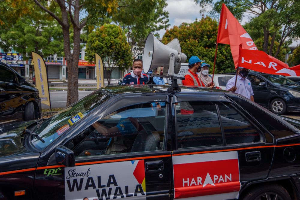 A vehicle equipped with public address system to play recorded messages on loudspeakers departs from Pakatan Harapanu00e2u20acu2122s command centre in Malim Jaya, Melaka November 9, 2021. u00e2u20acu2022 Picture by Shafwan Zaidon