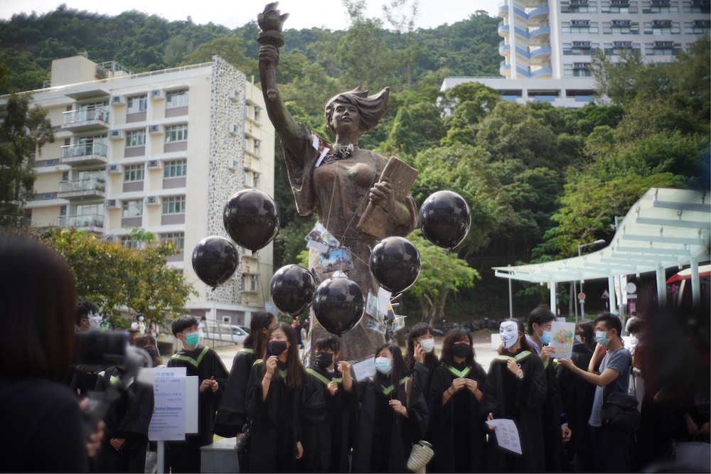 Students from the Chinese University of Hong Kong (CUHK) hold black balloons and placards as they gather at the statue of the u00e2u20acu02dcGoddess of Democracyu00e2u20acu2122 at a protest on campus, November 19, 2020. u00e2u20acu201d AFP file pic