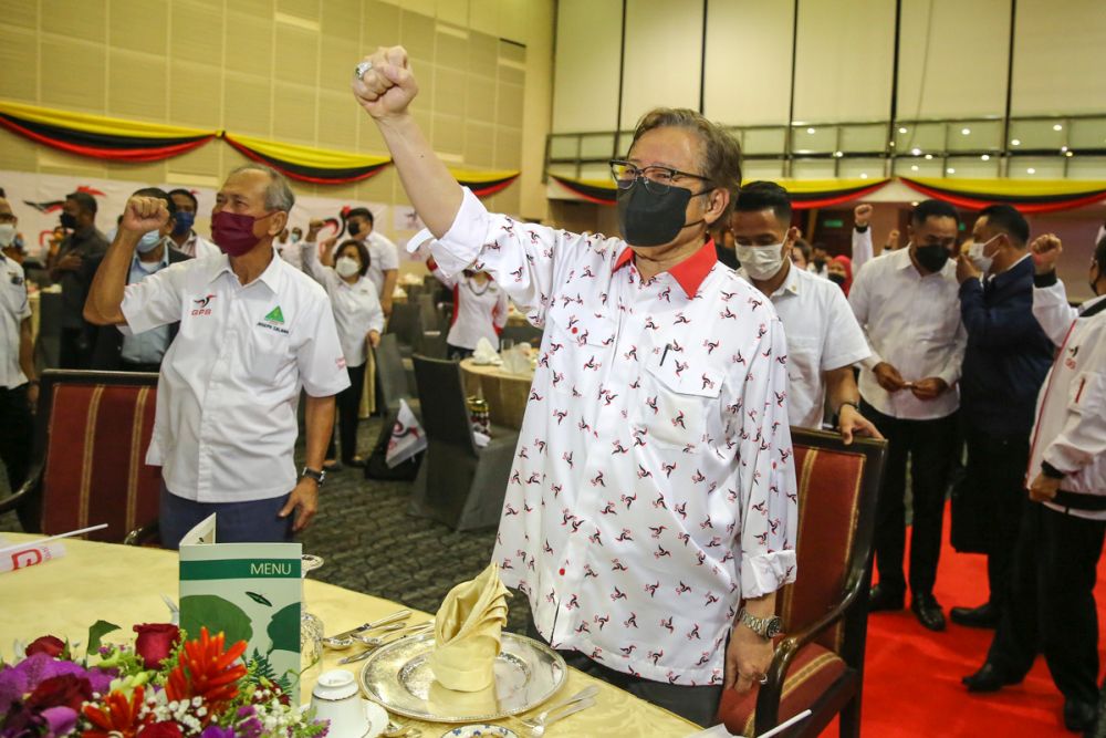 Gabungan Parti Sarawak chairman Tan Sri Abang Johari Openg pumps his fist as he celebrates the coalitionu00e2u20acu2122s victory in the state election at the Borneo Convention Centre, Kuching December 18, 2021. u00e2u20acu2022 Picture by Yusof Mat Isa