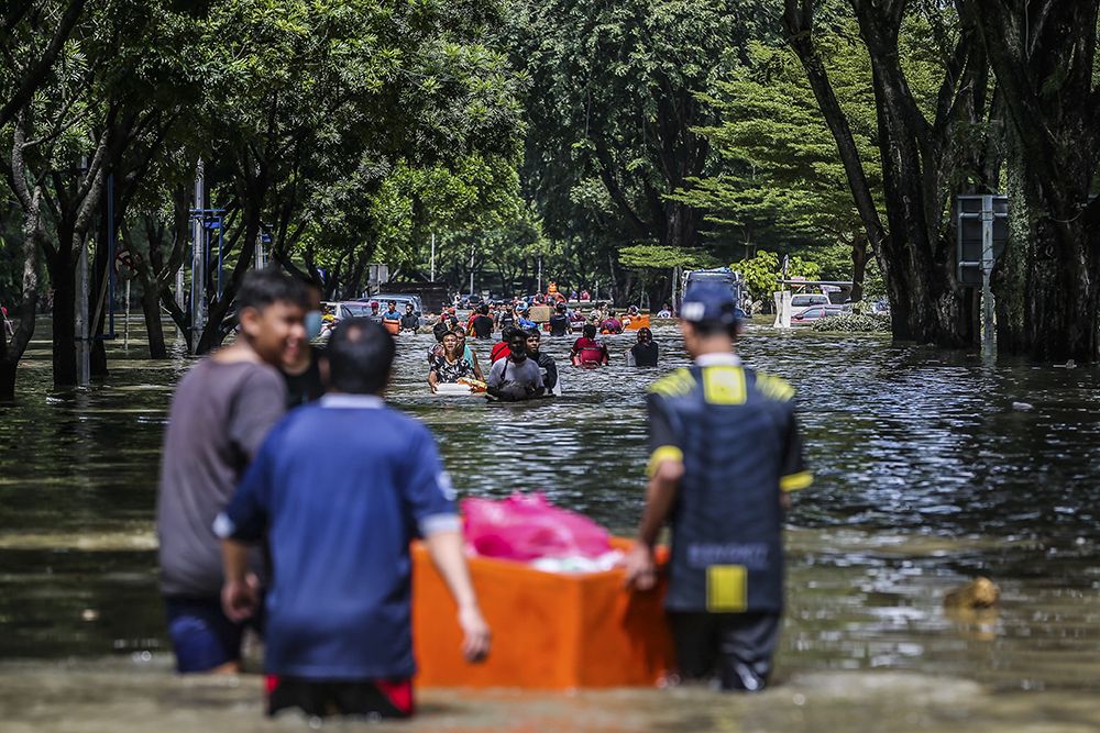 Flood victims evacuate their homes on boats and on foot in Taman Sri Muda, Shah Alam December 20, 2021.  u00e2u20acu201d Picture by Hari Anggaran n