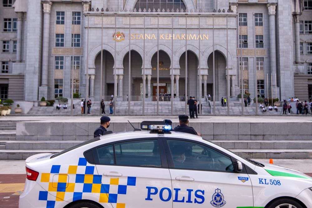 Police personnel are seen at the Palace of Justice in Putrajaya December 8, 2021. u00e2u20acu2022 Picture by Shafwan Zaidon