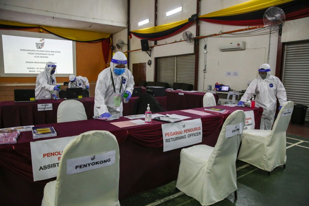Health workers wearing protective equipment disinfectant the nomination centre at Dewan Masyarakat Gedung, Sarawak December 6, 2021. u00e2u20acu201d Picture by Yusof Mat Isa