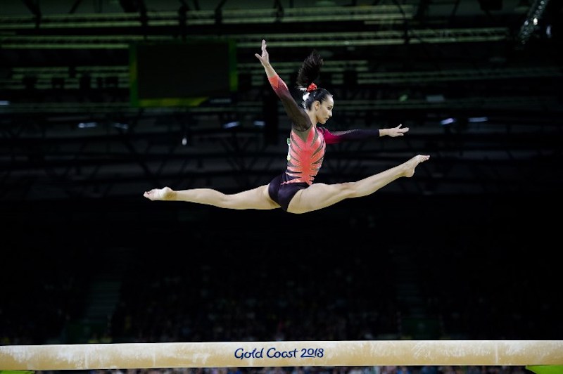 Farah Ann Abdul Hadi competes on the balance beam during the womenu00e2u20acu2122s team final and individual qualification in the artistic gymnastics event during the 2018 Commonwealth Games in Gold Coast, Australia April 6, 2018. u00e2u20acu201d AFP pic