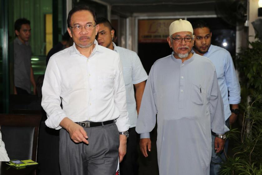 Datuk Seri Anwar and Datuk Seri Abdul Hadi Awang arriving at a meeting with other Pakatan Rakyat (PR) leaders before the 'Faham GST, Tolak GST' rally at the Sultan Sulaiman Club, Kg Baru today. u00e2u20acu201d Picture by Choo Choy May