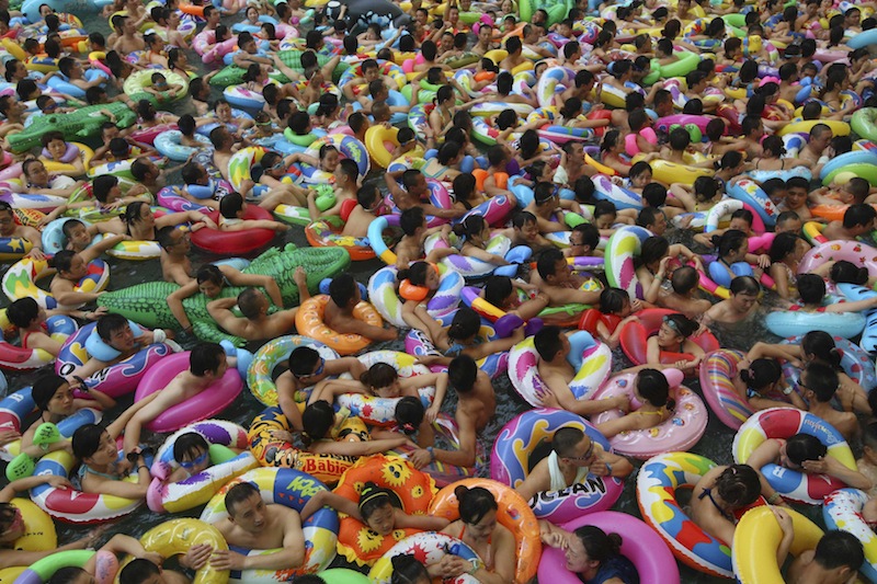 Visitors crowd an artificial wave pool at a tourist resort to escape the summer heat in Daying county of Suining, Sichuan province, July 27, 2013. u00e2u20acu201d Reuters pic