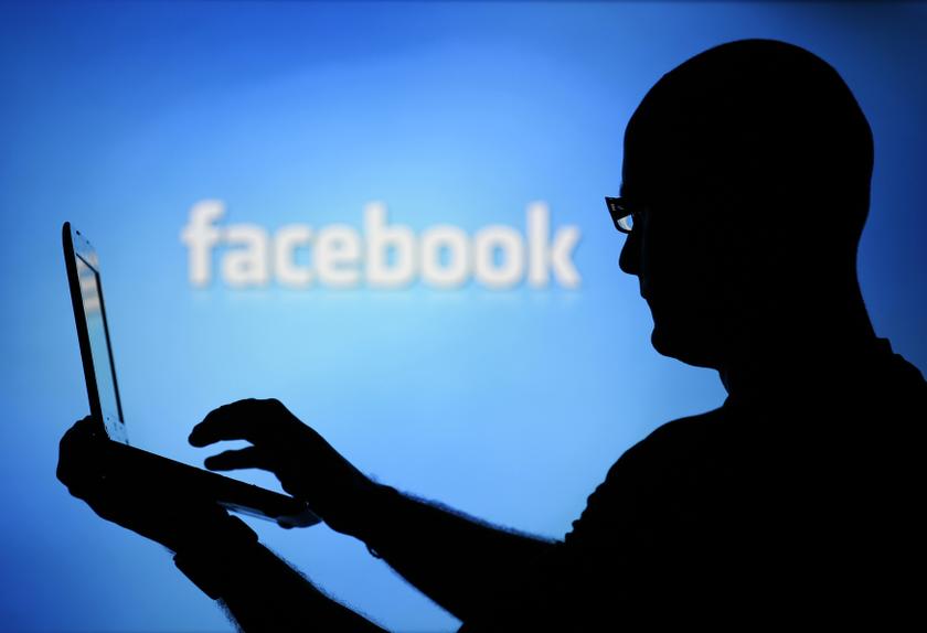 File photo of a man is silhouetted against a video screen with a Facebook logo as he poses with a laptop in this photo illustration. u00e2u20acu201d Reuters pic