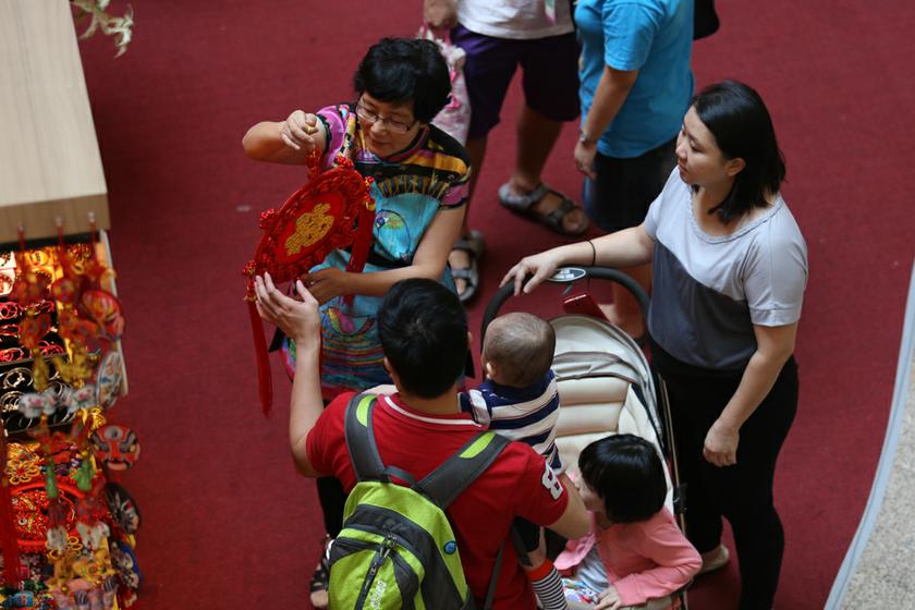 A family look at Chinese New Year decorations on sale at a shopping mall in Kuala Lumpur. u00e2u20acu201d Picture by Saw Siow Feng
