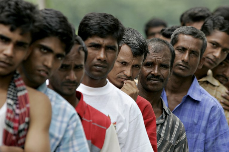  This file photo taken on December 25, 2007 shows Bangladeshi migrant workers waiting in line for food donated by a goodwill charity group for Christmas outside the Bangladeshi High Commission in Kuala Lumpur. u00e2u20acu201d AFP pic