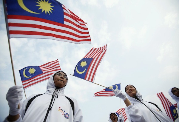 Malaysian youths wave national flags during the National Day celebrations marking the 56th anniversary of the countryu00e2u20acu2122s independence in Kuala Lumpur August 31, 2013. u00e2u20acu201d Reuters pic
