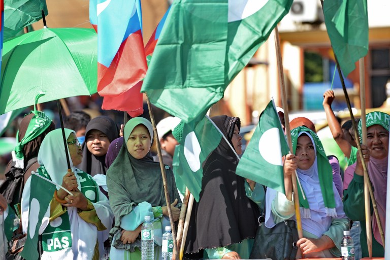 Supporters of the opposition of the Islamic party PAS wait outside the nomination centre in Pekan on April 20, 2013. u00e2u20acu201c AFP pic