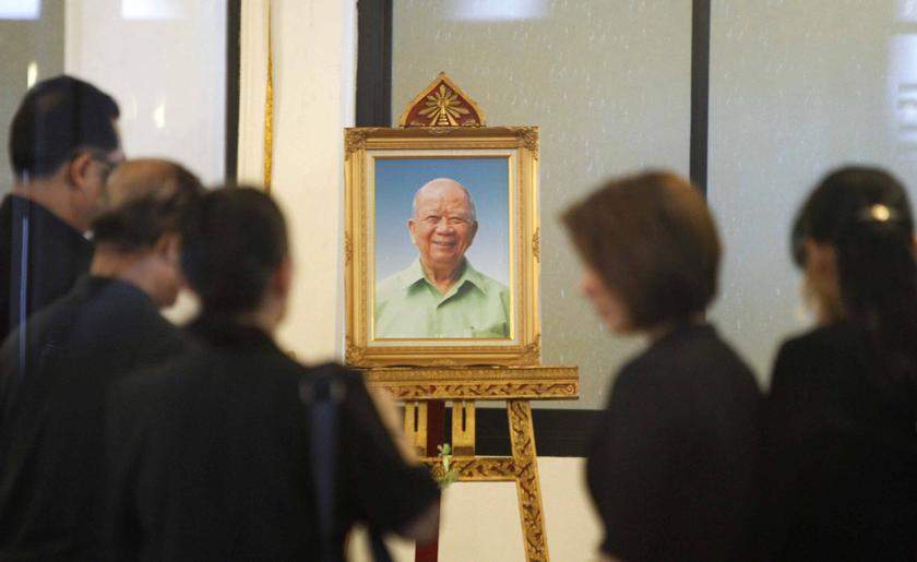 Relatives and mourners stand in front of a portrait of former Malayan Communist Party leader Chin Peng during his funeral at a temple in Bangkok September 20, 2013. u00e2u20acu201d Reuters pic