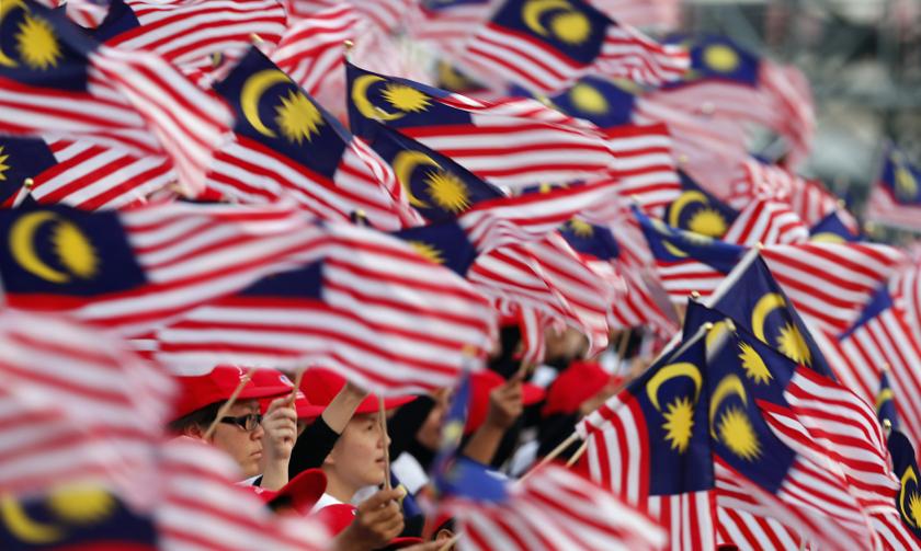 Malaysian wave national flags during National Day celebrations marking the 56th anniversary of the country's independence, at Independence Square in Kuala Lumpur August 31, 2013. u00e2u20acu201d Reuters pic