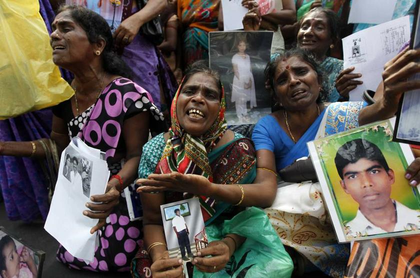Tamil women cry as they hold up images of their disappeared family members during the war against Liberation Tigers of Tamil Eelam, at a protest in Jaffna, Sri Lanka on August 27, 2013. u00e2u20acu201d Reuters pic